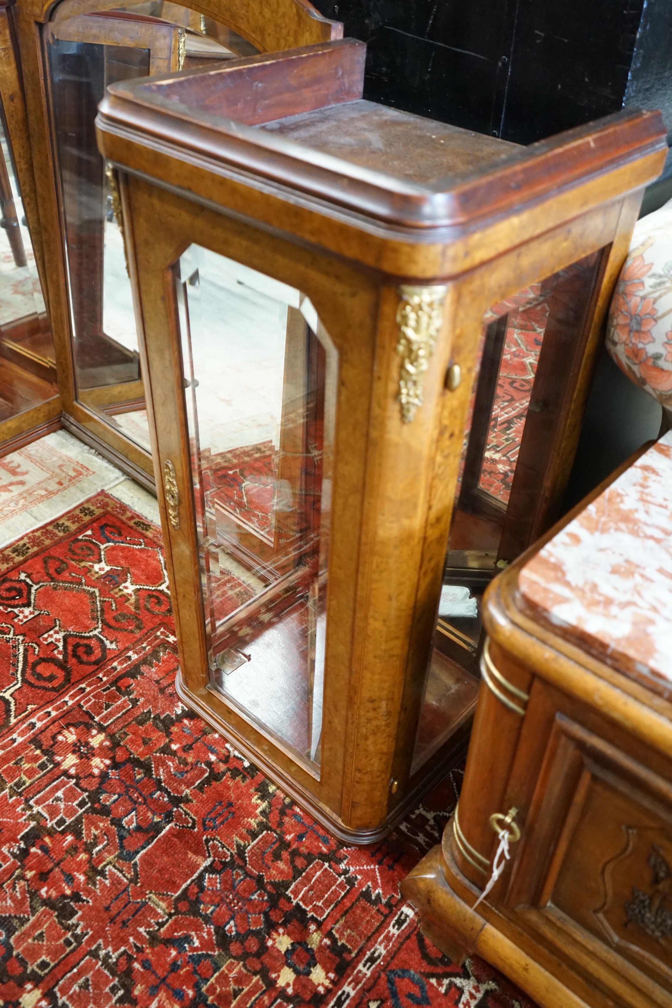 A pair of early 20th French birds eye maple glazed cabinets and central mirror, formerly a cabinet superstructure, total width approximately 156cm